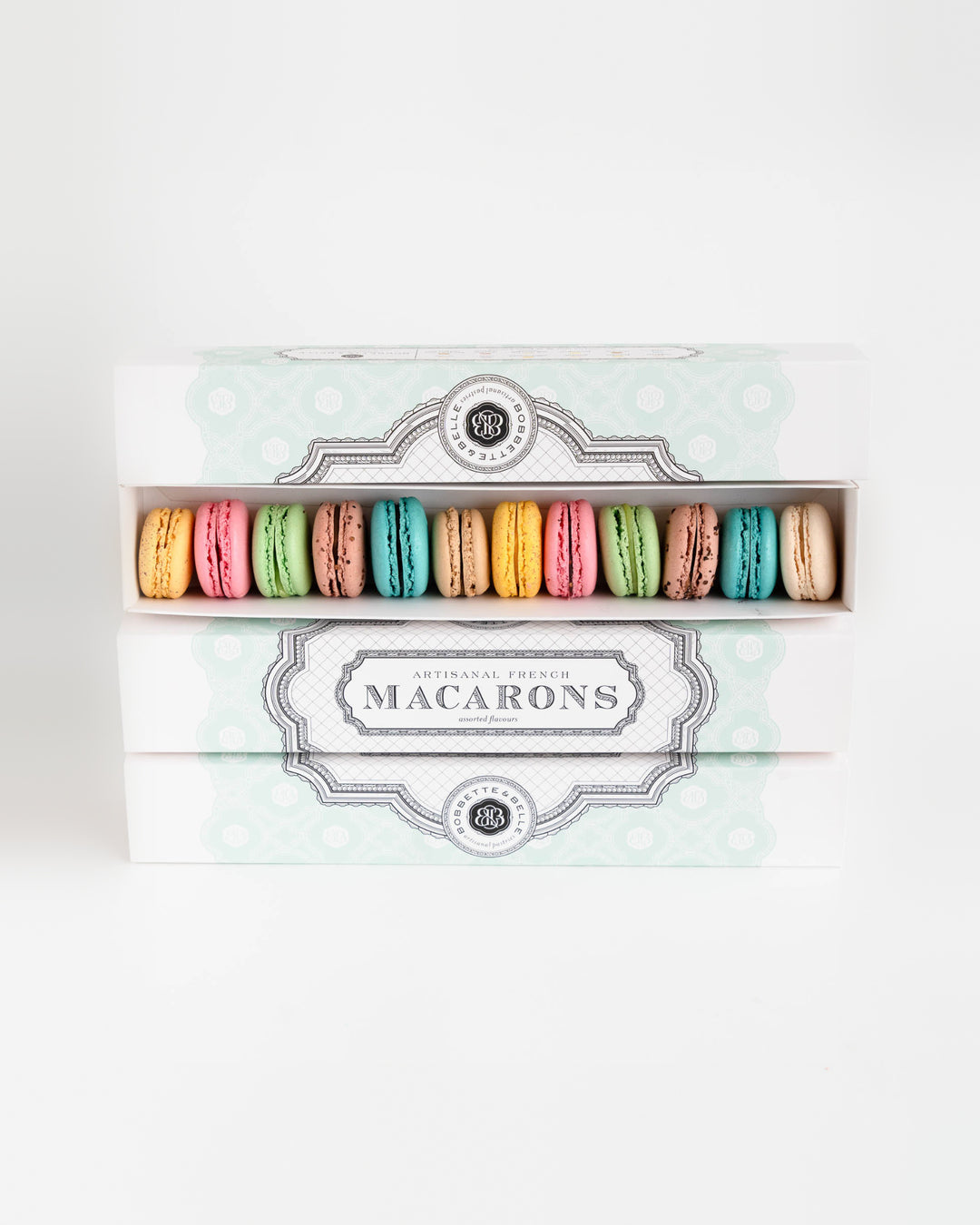 Box of 12 assorted French macarons in pastel colours, by Bobbette & Belle Toronto