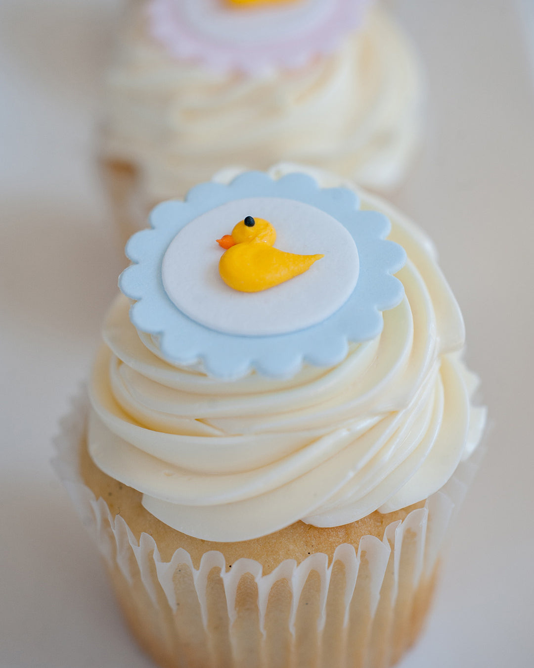Baby Duckie Cupcake Favour by Bobbette & Belle, a cupcake topped with a sugar duck