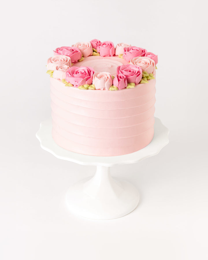 Cake covered in pink piped buttercream roses, by Bobbette & Belle Toronto