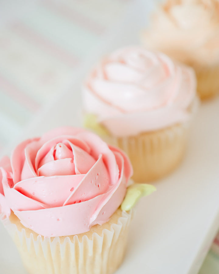 Cupcakes piped with buttercream roses, by Bobbette & Belle Toronto