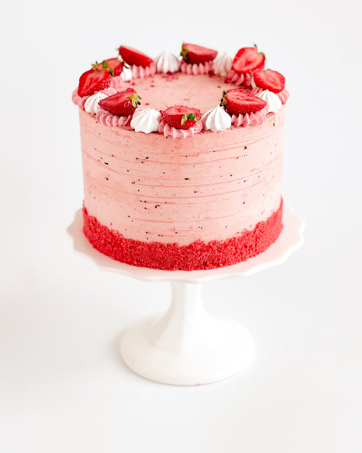 Classic strawberry shortcake layer cake with fresh strawberries and whipped cream