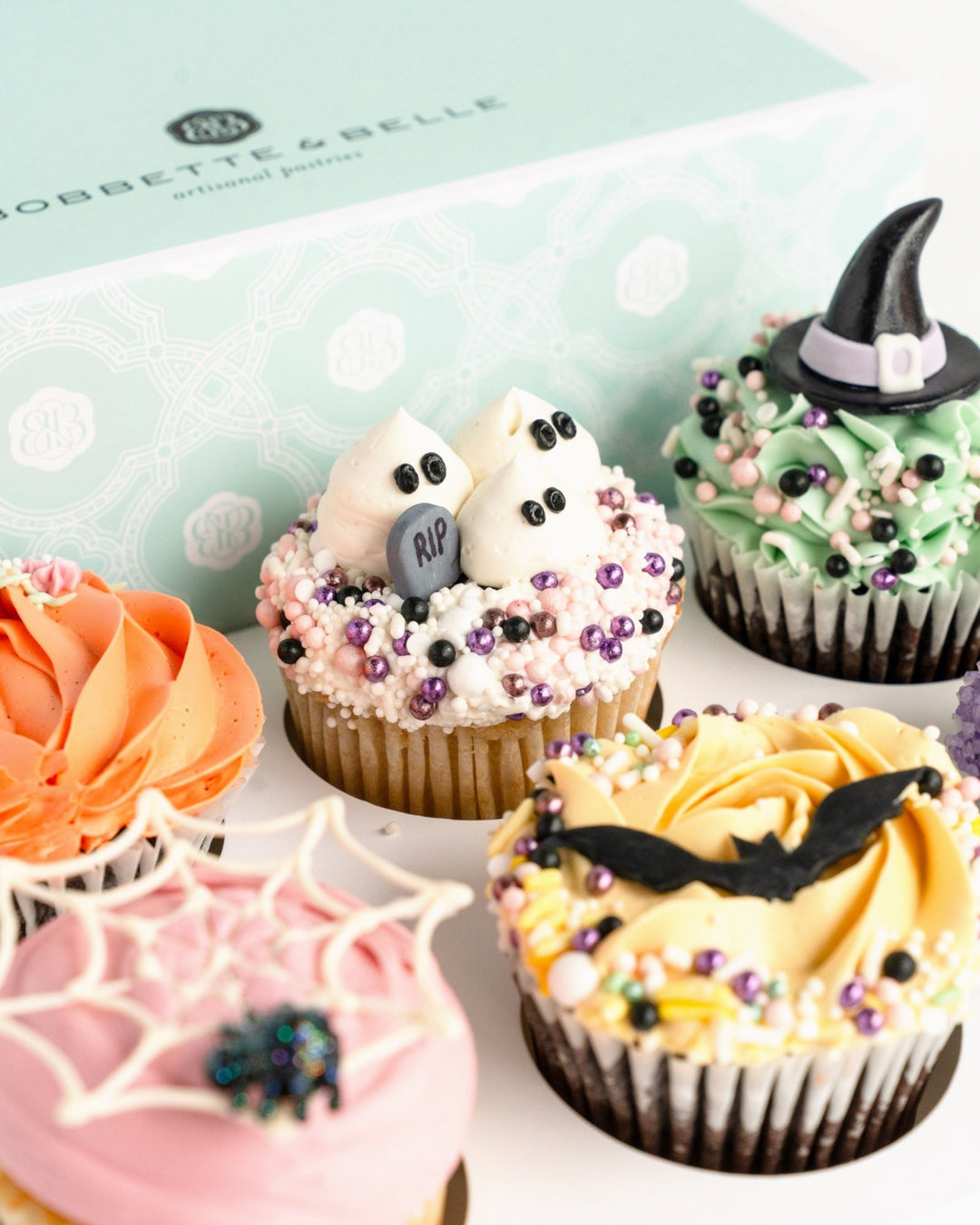 Halloween cupcakes with ghosts, witch hat, bat and spiderweb