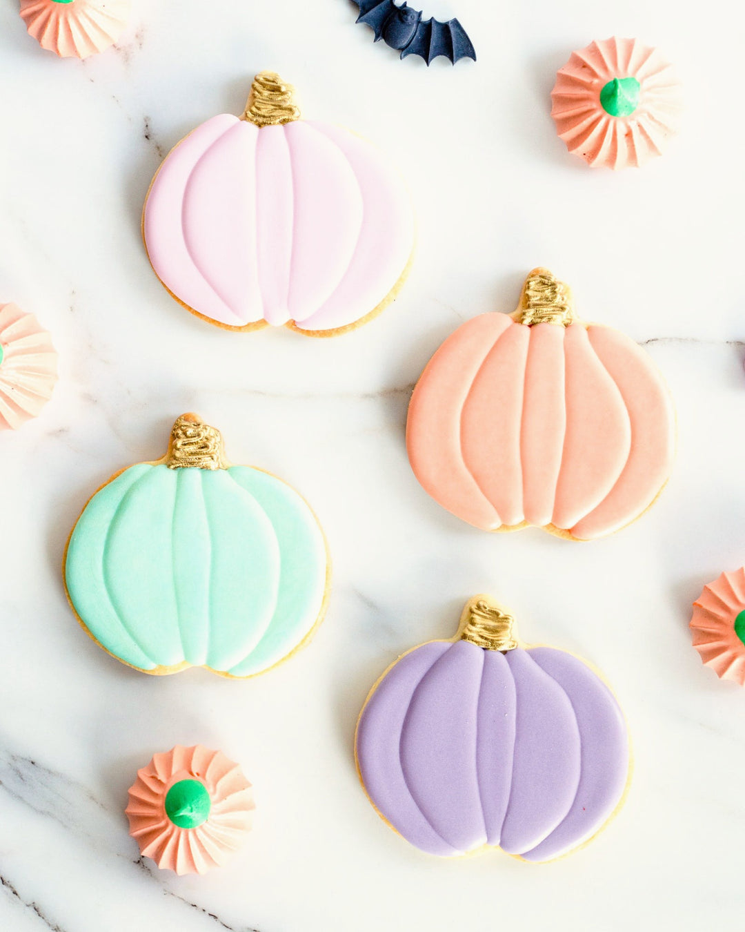 Pastel pumpkin Halloween sugar cookies with gold stems