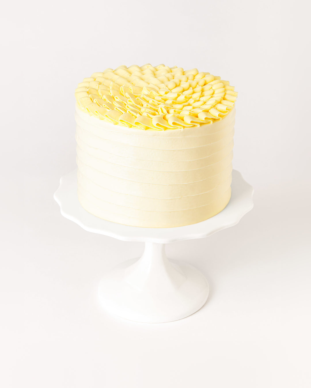 Lemon cream cake with lemon curd and piped vanilla buttercream, by Bobbette & Belle