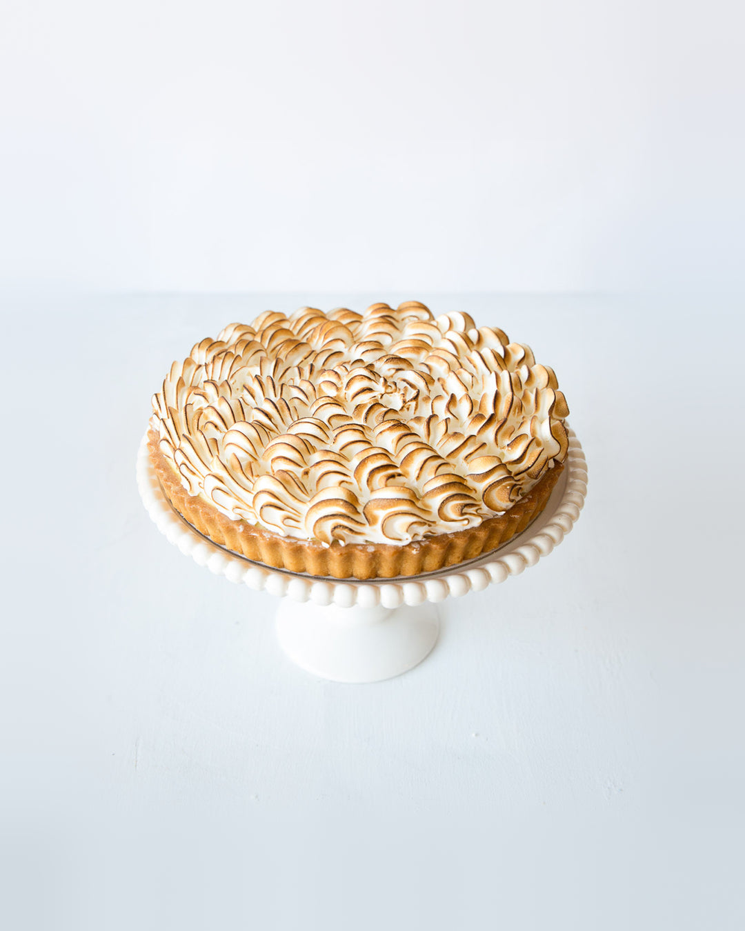 Lemon meringue pie with lemon curd, short crust and golden toasted meringue