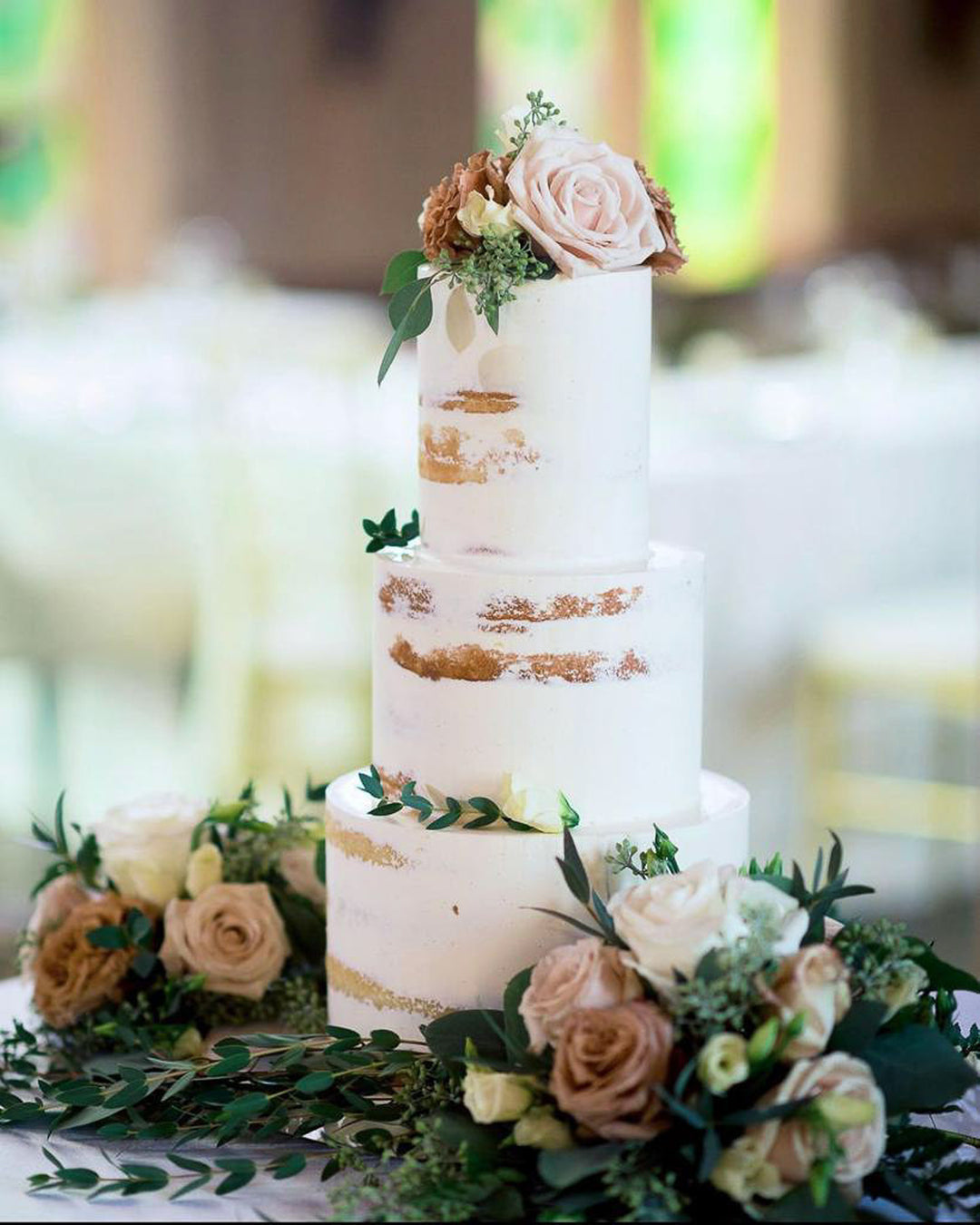 Naked Cake by Bobbette & Belle with lightly frosted sides and visible layers