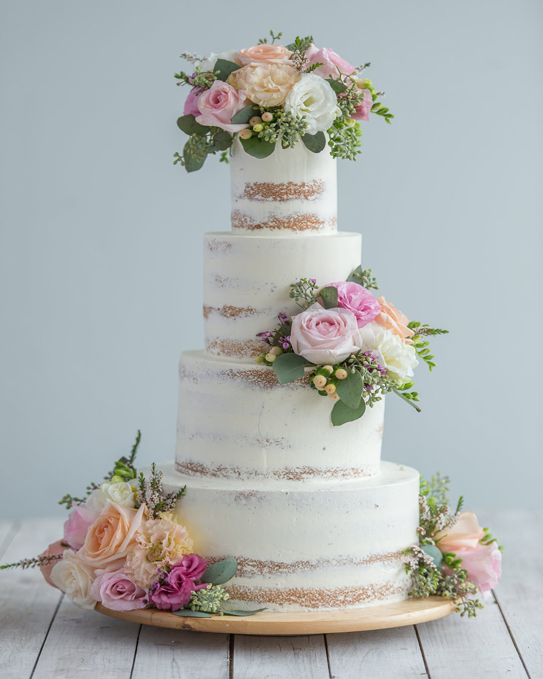 Nearly naked buttercream wedding cake with fresh flowers, by Bobbette & Belle Toronto