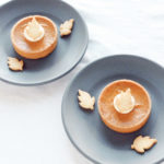 Individual-sized pumpkin pie with buttery crust, spiced pumpkin filling, whipped cream, and a shortbread cookie leaf, perfect for Thanksgiving and fall treats