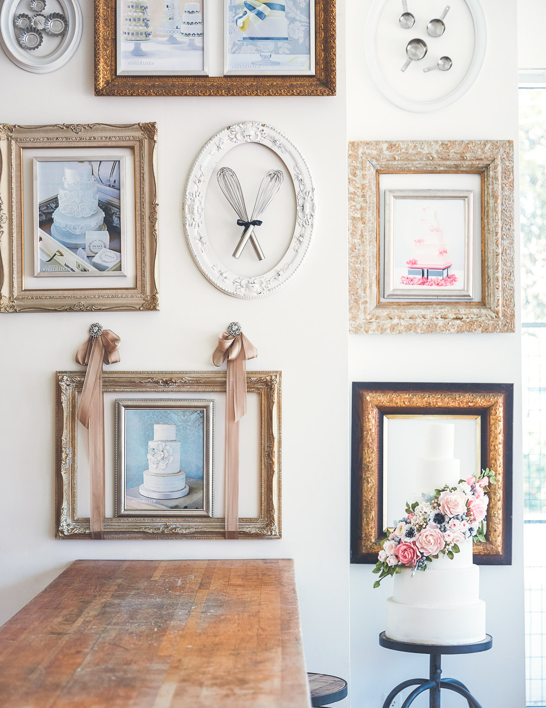 Handmade wedding cake with sugar flowers displayed inside our Queen Street East bakery store