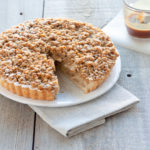 Full-sized apple crumble pie with spiced apples and a golden buttery crumble topping, perfect for family gatherings and dessert lovers