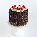 Classic Black Forest cake with chocolate sponge, whipped cream, Amarena cherries, and chocolate ganache glaze