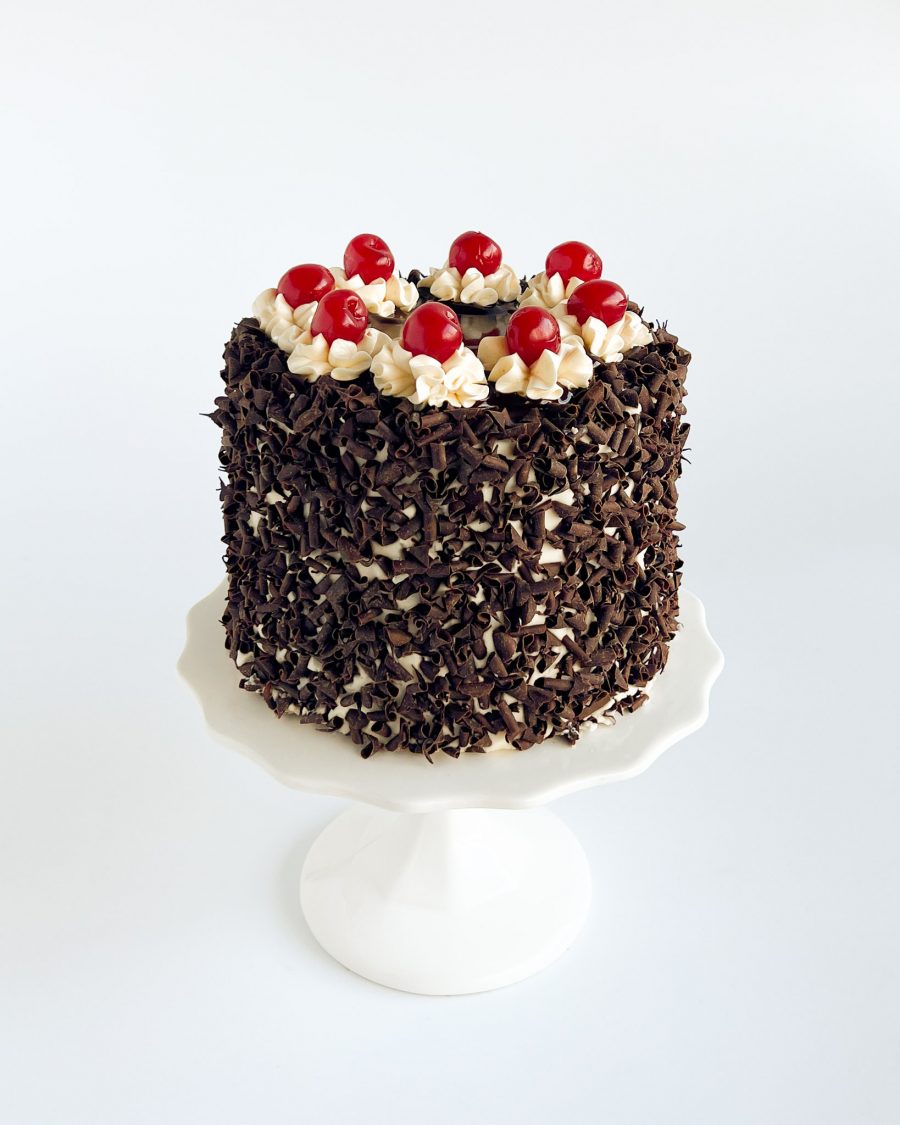 Classic Black Forest cake with chocolate sponge, whipped cream, Amarena cherries, and chocolate ganache glaze