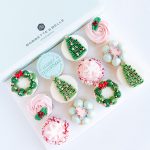 Assorted holiday cupcakes featuring Christmas trees, wreaths, and snowflakes, with tinted vanilla buttercream frosting, in a 6 or 12 pack