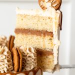 Slice of Biscoff cake showing vanilla sponge layers and biscoff cookie cream filling