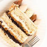 slice of caramel hazelnut Dacquoise cake with chocolate cake layers and salted caramel