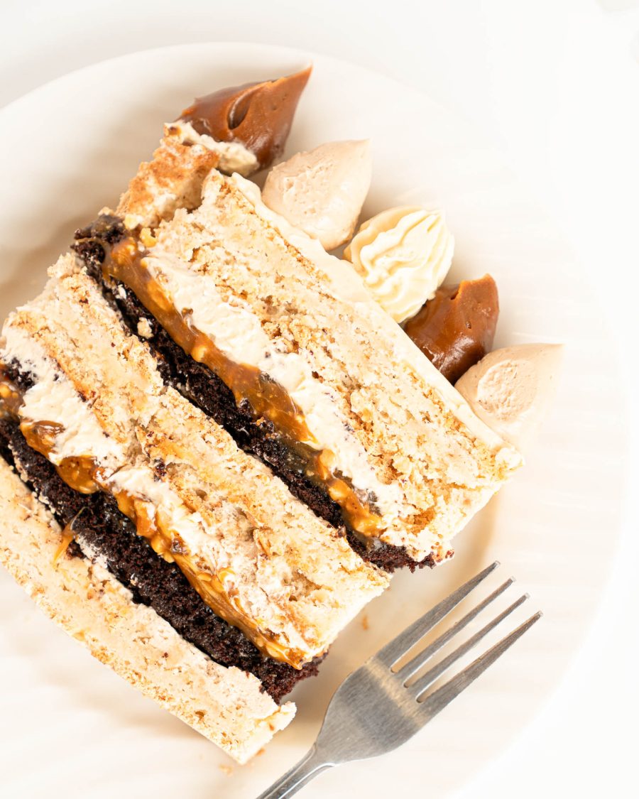 slice of caramel hazelnut Dacquoise cake with chocolate cake layers and salted caramel