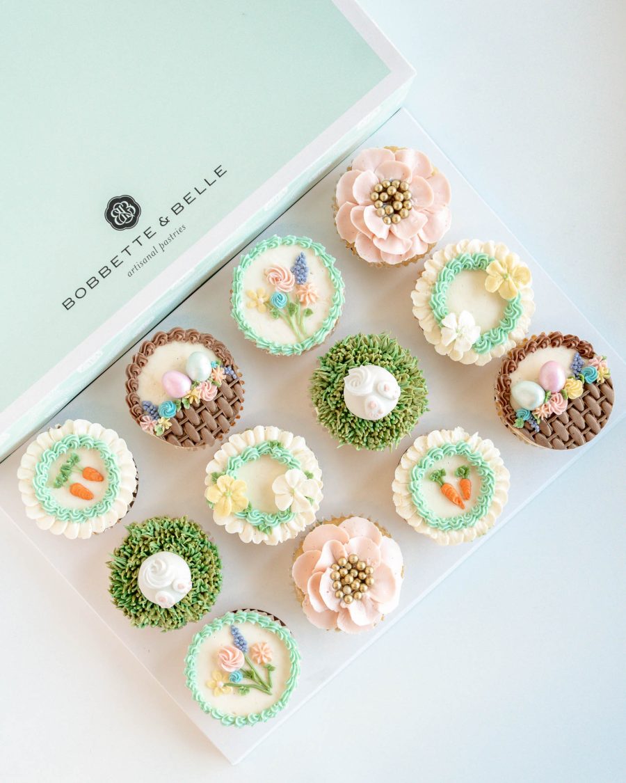 Easter cupcakes decorated with pastel buttercream flowers, nests, and bunny designs