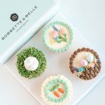 Four Easter Garden cupcakes decorated with pastel buttercream florals, nests, and bunny details.