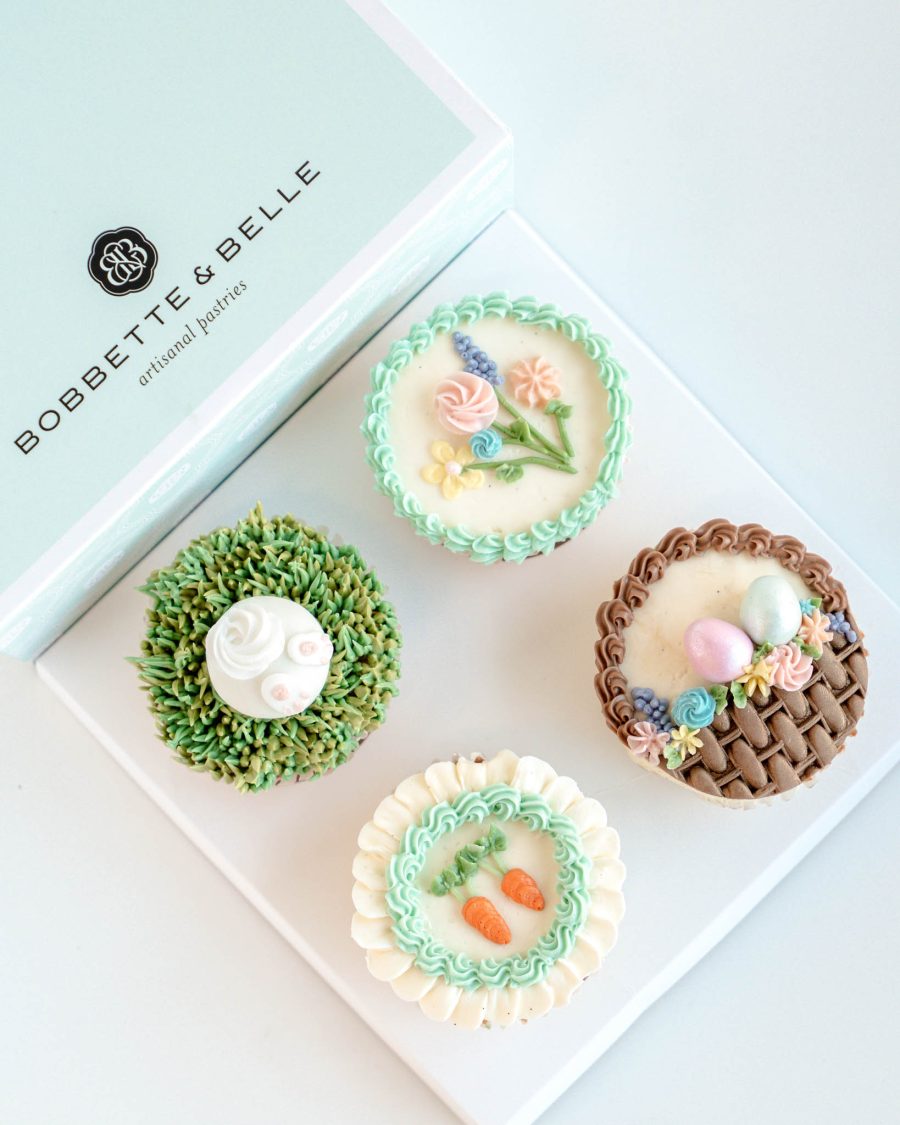 Four Easter Garden cupcakes decorated with pastel buttercream florals, nests, and bunny details.