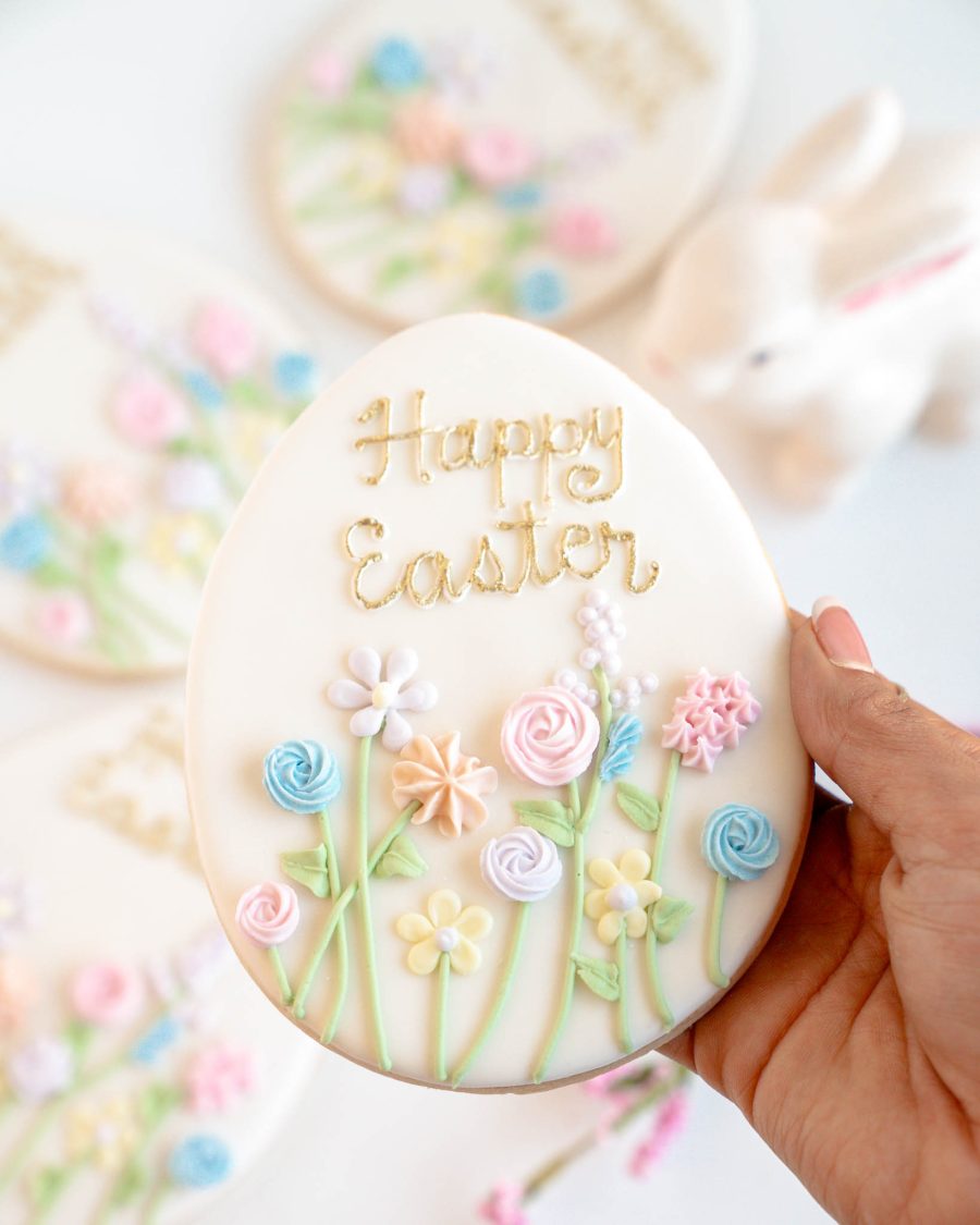 Easter egg sugar cookie with pastel floral icing and Happy Easter lettering, packaged for gifting