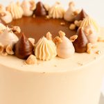 close-up caramel hazelnut Dacquoise cake topping with caramel buttercream and hazelnuts