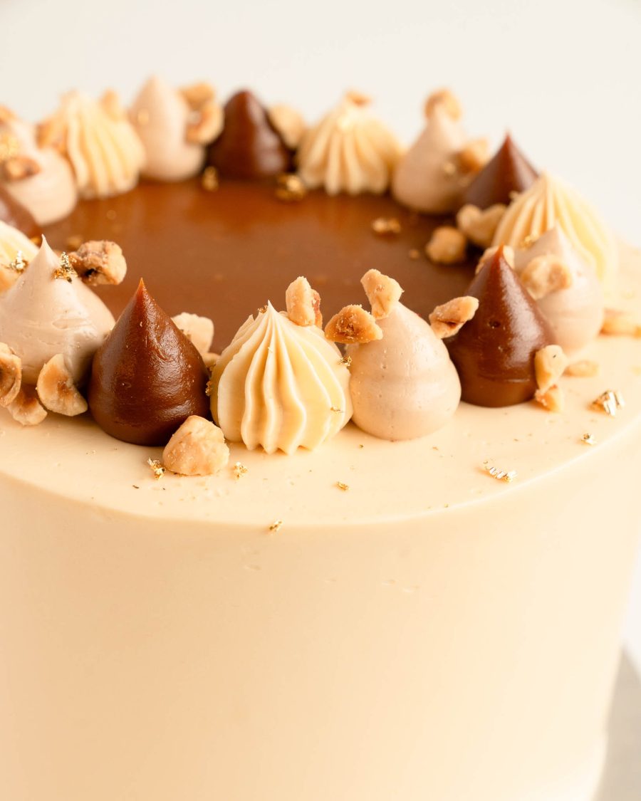 close-up caramel hazelnut Dacquoise cake topping with caramel buttercream and hazelnuts