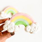 Hand-decorated rainbow sugar cookie with cloud details for St. Patrick’s Day