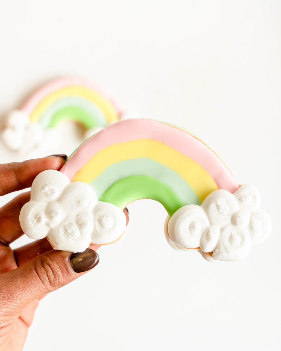Hand-decorated rainbow sugar cookie with cloud details for St. Patrick’s Day