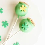 Green St. Patrick’s Day vanilla cake pops decorated with shamrocks and gold sprinkles