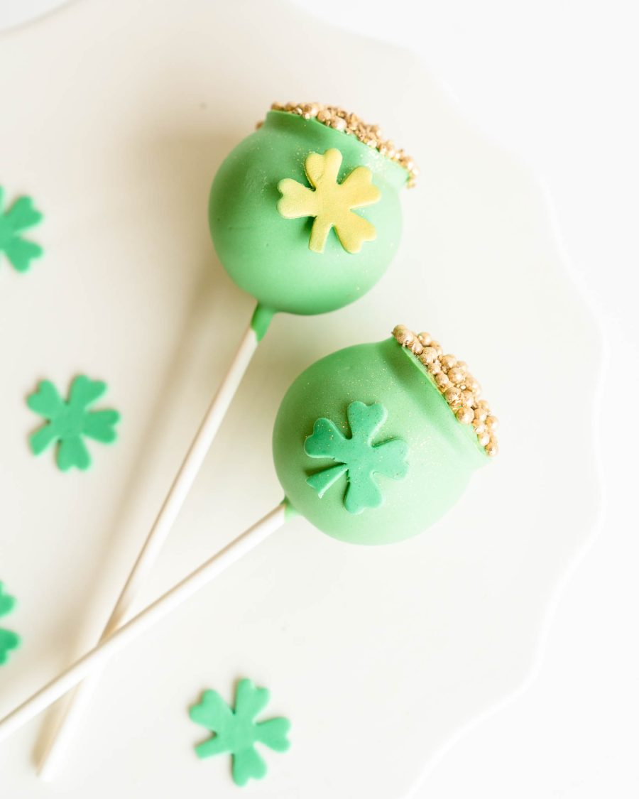 Green St. Patrick’s Day vanilla cake pops decorated with shamrocks and gold sprinkles