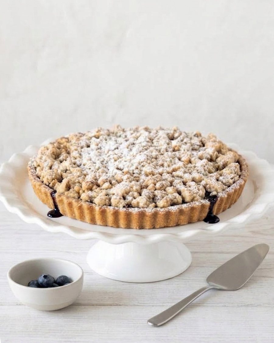 Blueberry crumble with wild blueberries, buttery short crust, and brown sugar oat topping, perfect with ice cream or whipped cream.