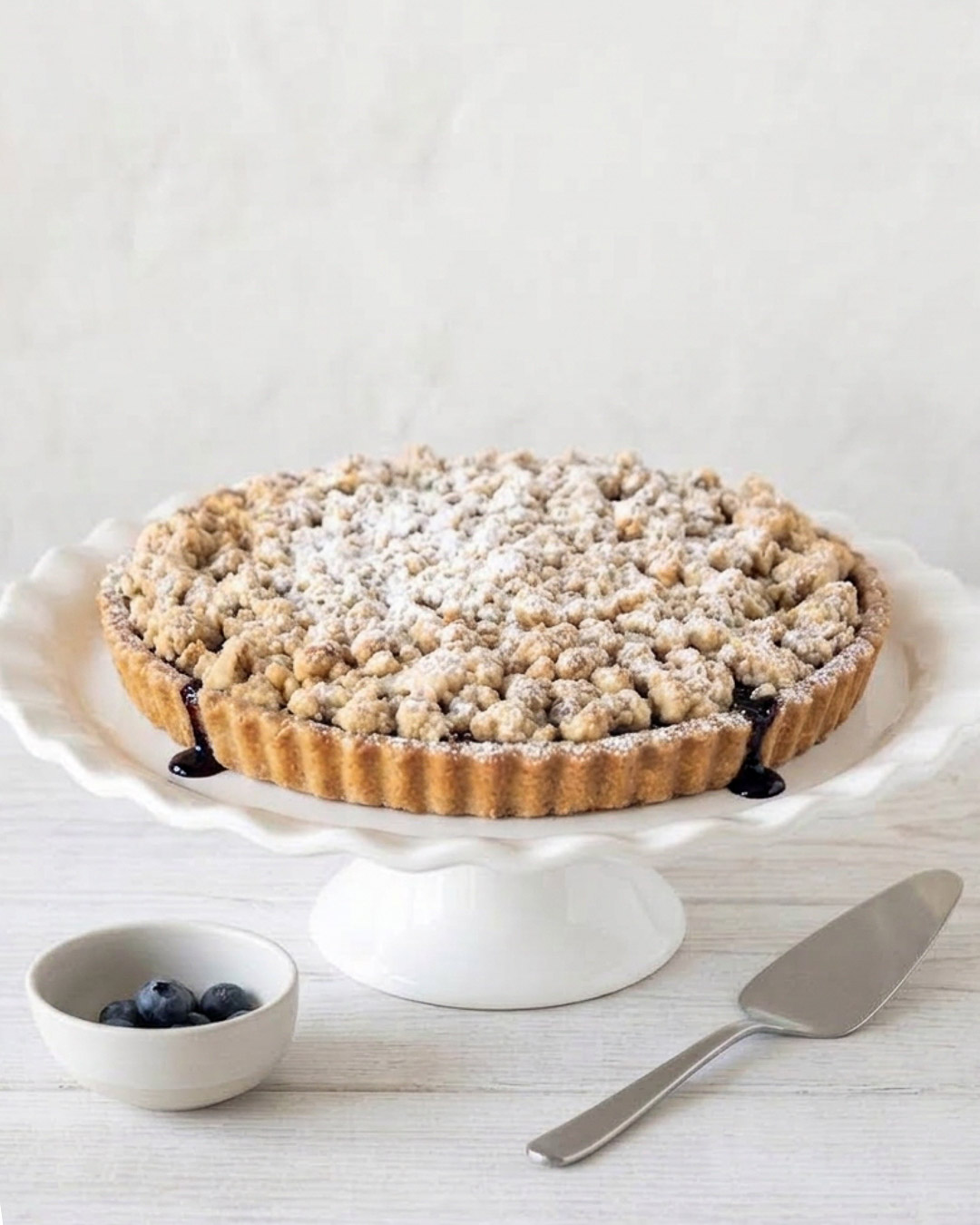 Blueberry crumble with wild blueberries, buttery short crust, and brown sugar oat topping, perfect with ice cream or whipped cream.